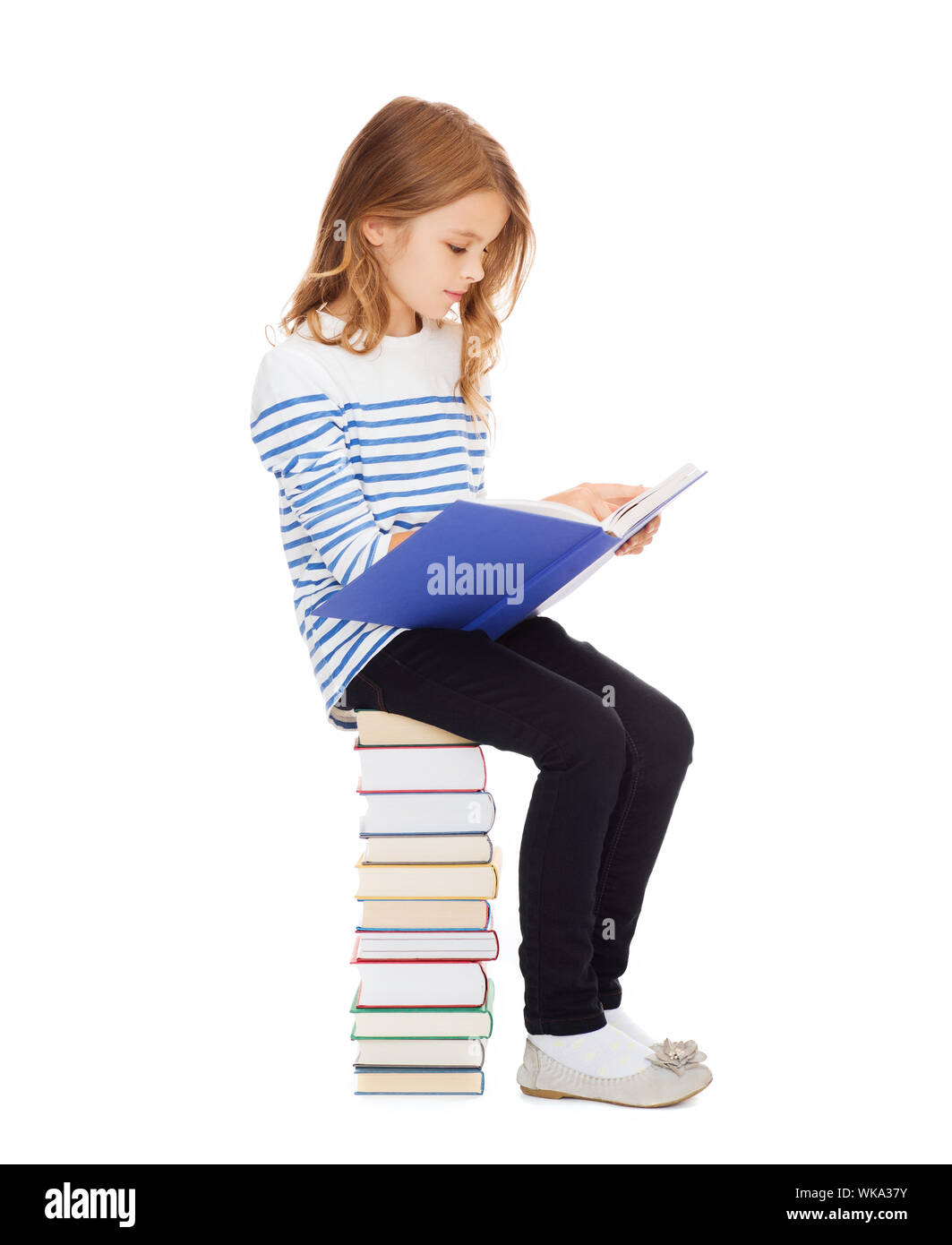 little student girl sitting on stack of books Stock Photo - Alamy
