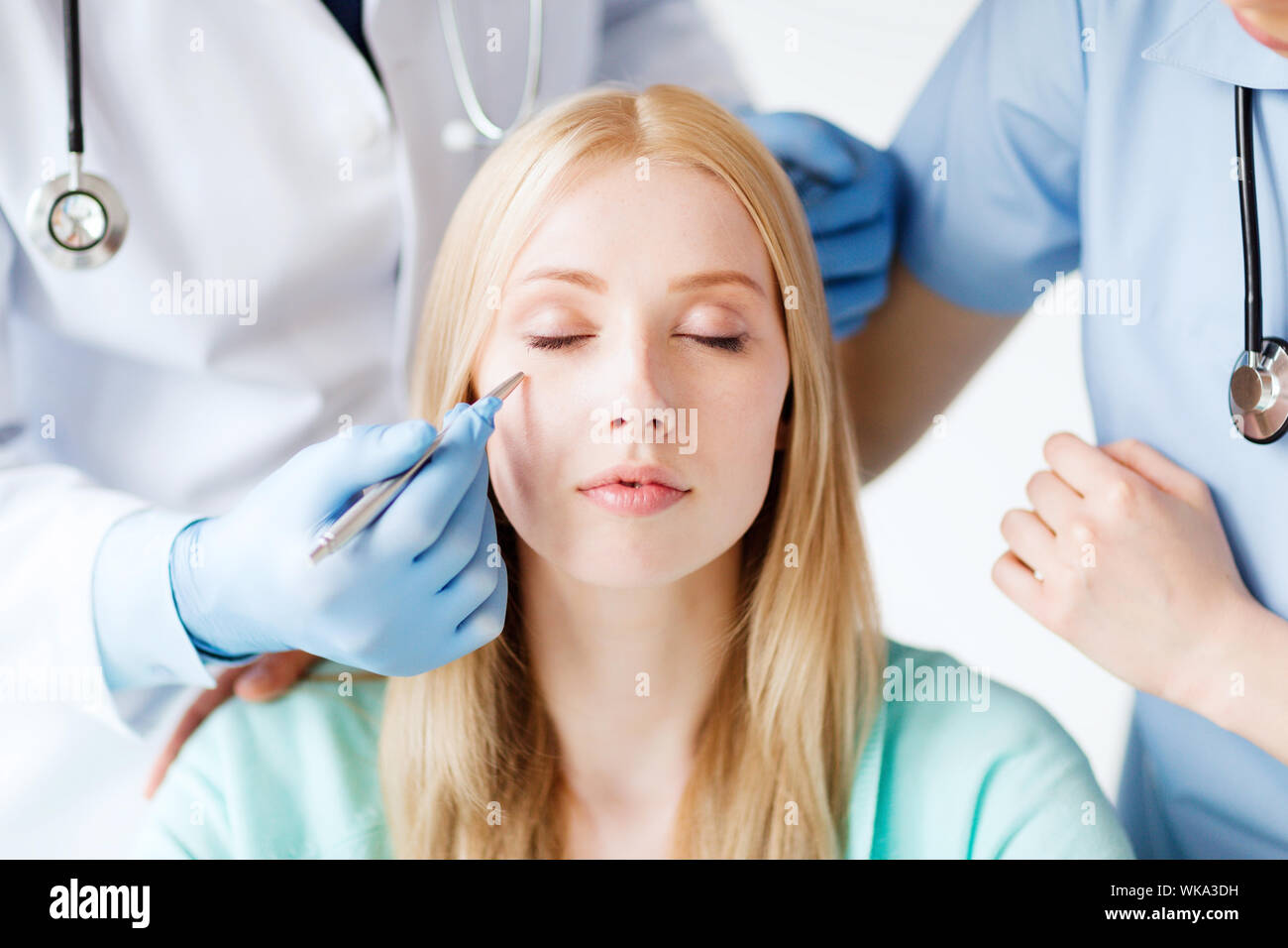 plastic surgeon and nurse with patient Stock Photo Alamy