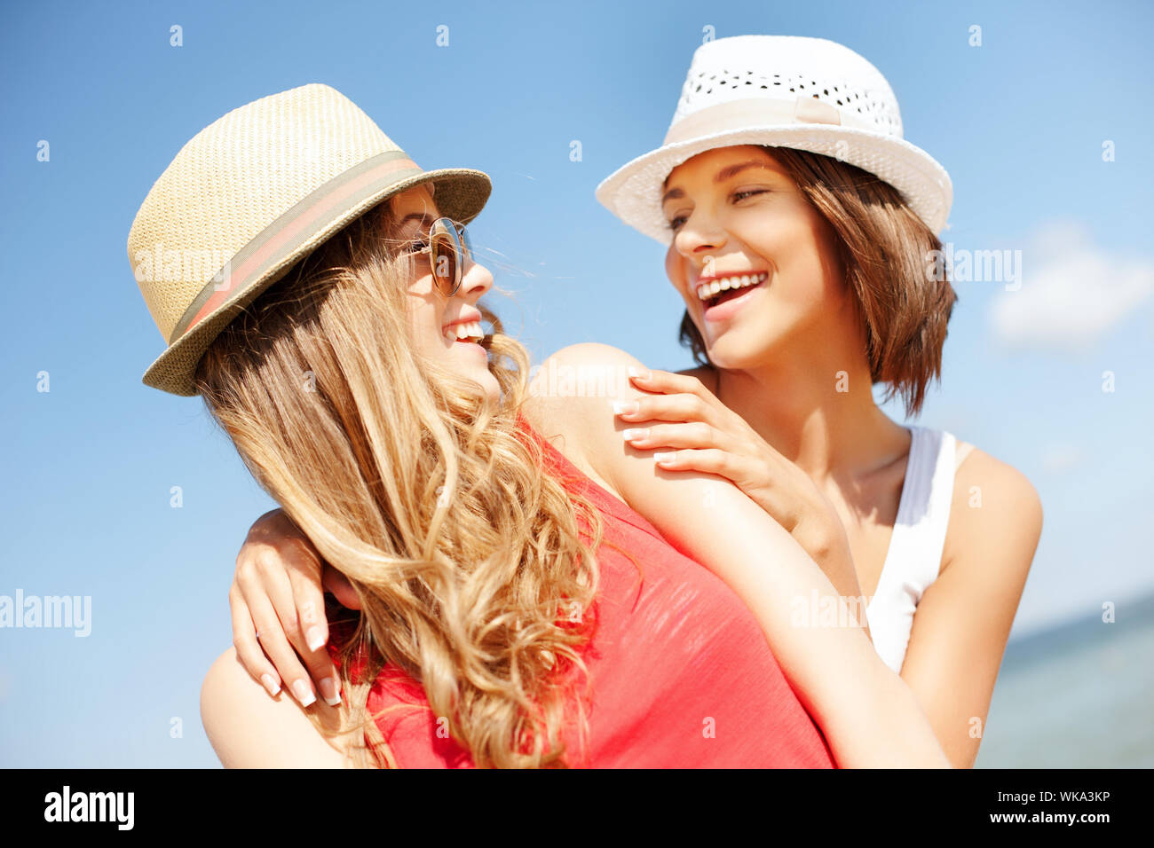 girls in hats on the beach Stock Photo Alamy
