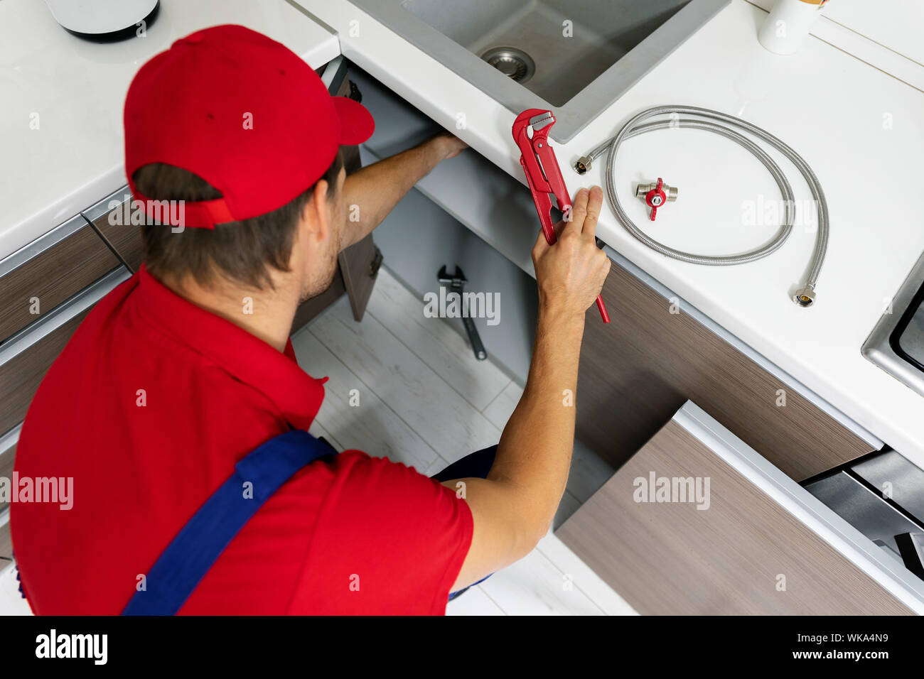 Man repairing kitchen sink hires stock photography and images Alamy