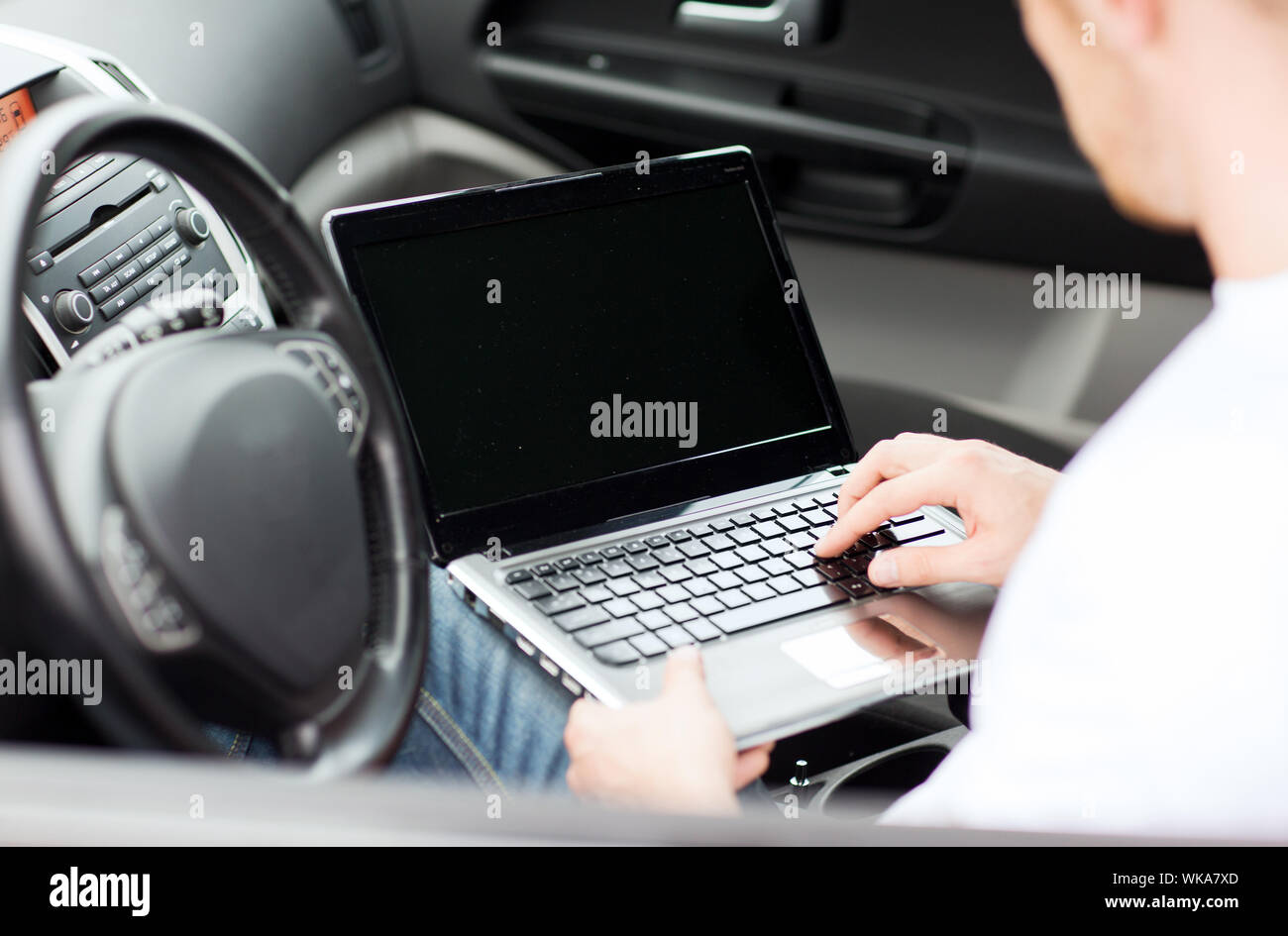 man using laptop computer in car Stock Photo