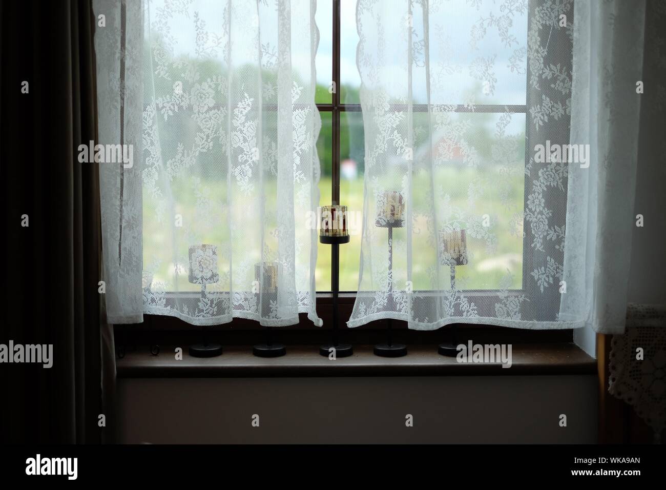 Candlestick Holders On Window At Home Stock Photo Alamy