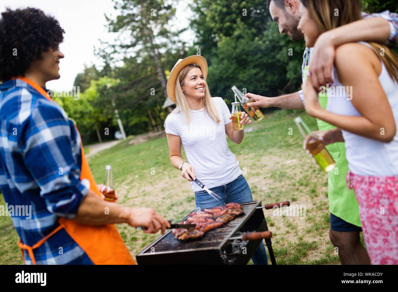 Group of happy friends having a barbecue party in nature Stock Photo ...