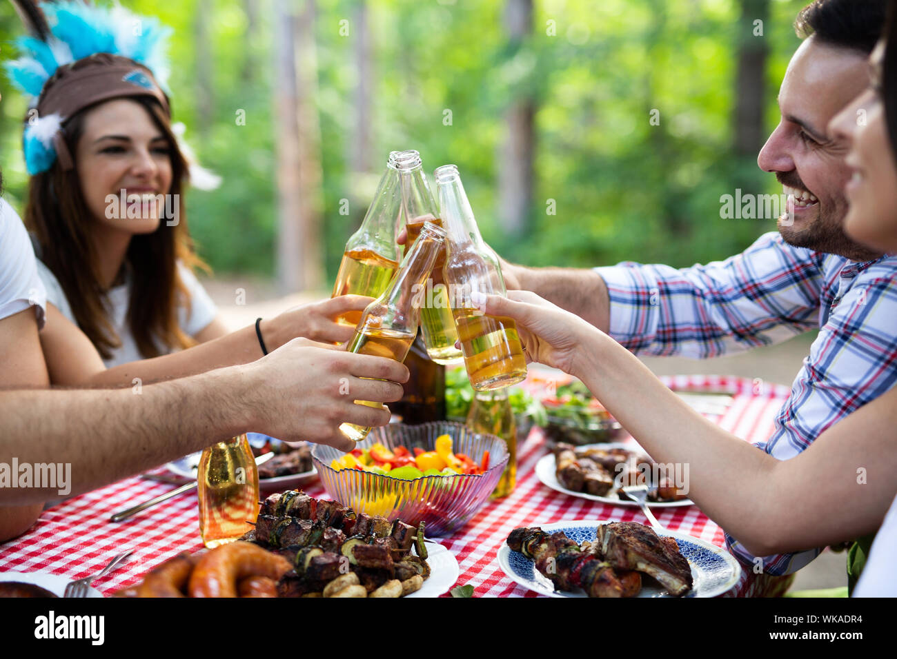 Group of happy friends having a barbecue party in nature Stock Photo ...