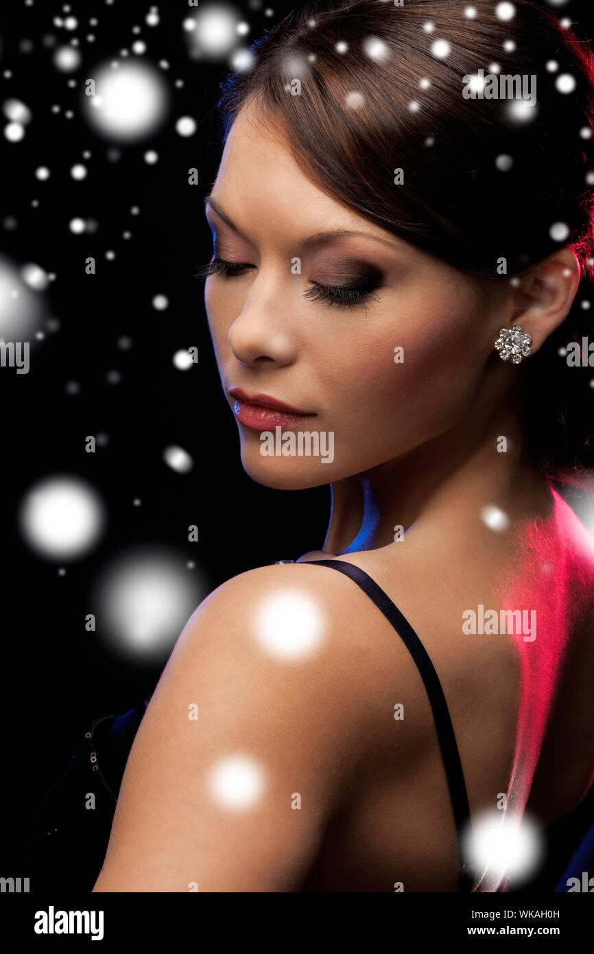 woman in evening dress wearing diamond earrings Stock Photo Alamy