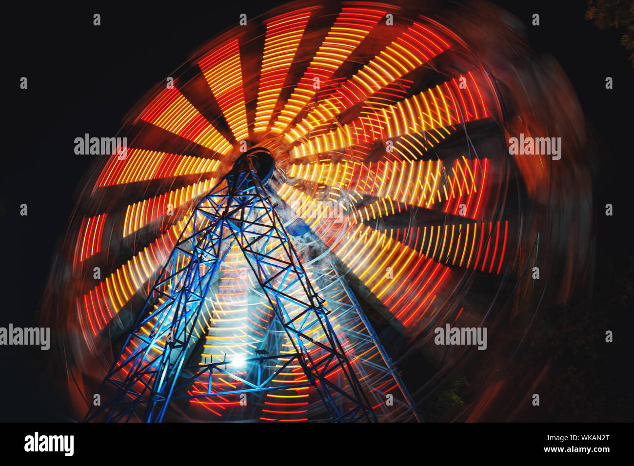 Ferris Wheel at county fair at night, motion blurred. Stock Photo