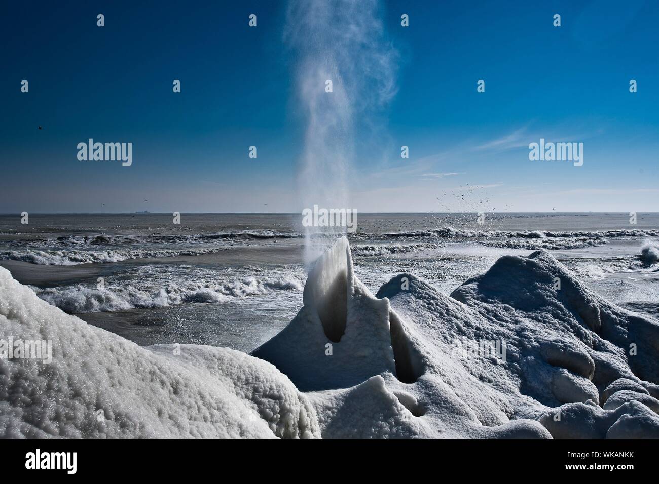 Steam Emitting From Hot Spring At Beach During Sunny Day Stock Photo