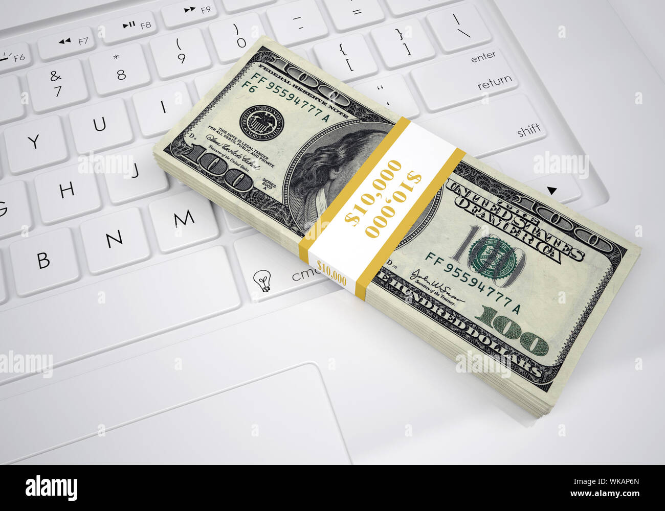 Bundle of dollar bills lying on a computer keyboard. View from above ...