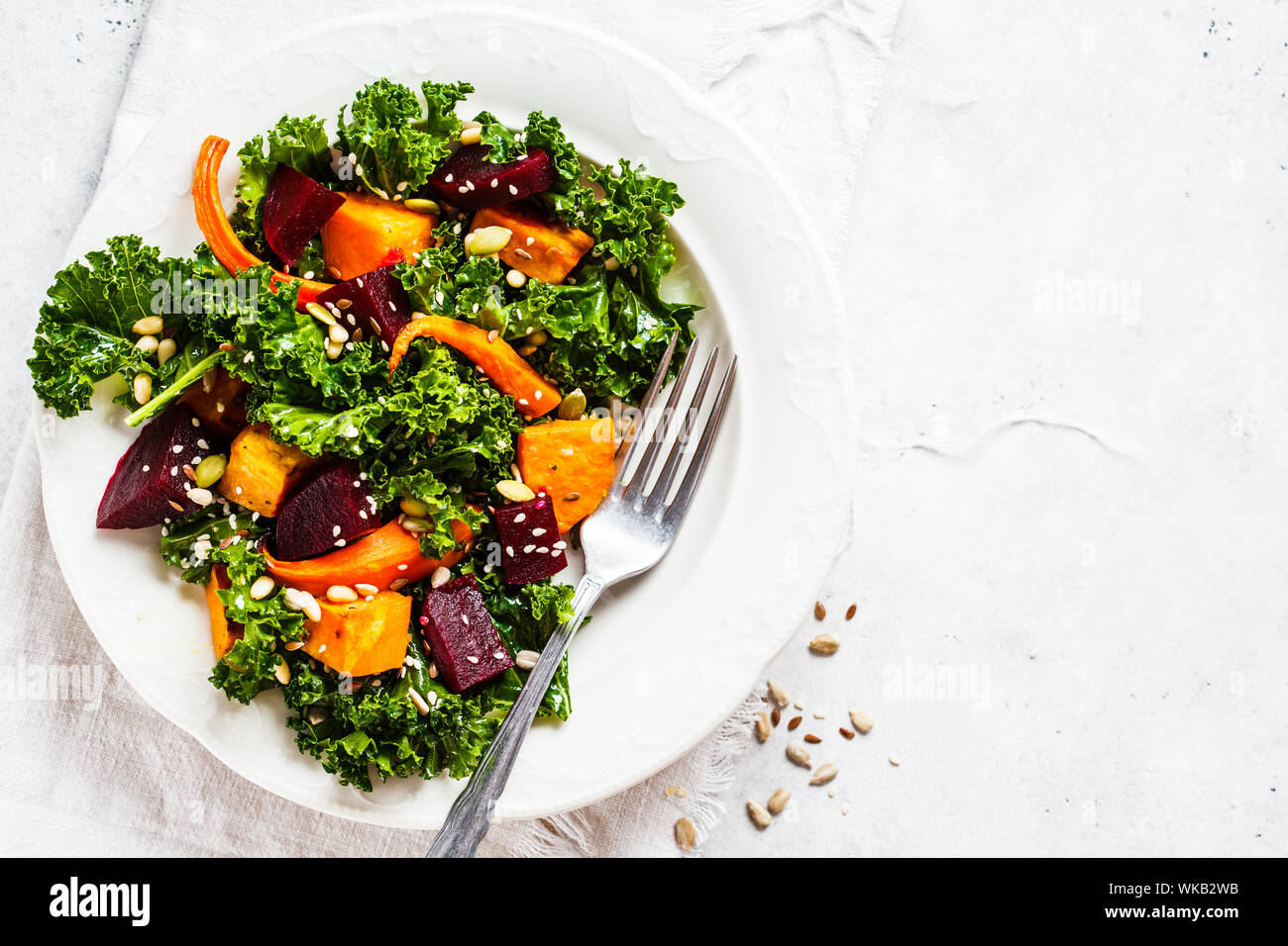 Kale salad with baked sweet potato, carrot and beet in a white plate Stock  Photo - Alamy