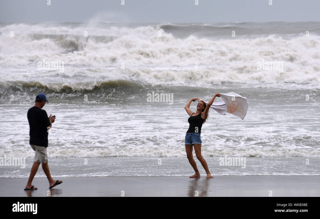Cocoa Beach, United States. 03rd Sep, 2019. A couple enjoys the wind and heavy surf as Hurricane Dorian turns to the north off the eastern coast of Florida after a weakened Category 2 storm devastates parts of the Bahamas. Credit: SOPA Images Limited/Alamy Live News Stock Photo