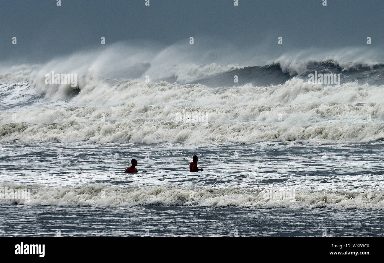 Cocoa Beach, United States. 03rd Sep, 2019. Two men enjoy the heavy waves as Hurricane Dorian turns to the north off the eastern coast of Florida after a weakened Category 2 storm devastates parts of the Bahamas. Credit: SOPA Images Limited/Alamy Live News Stock Photo