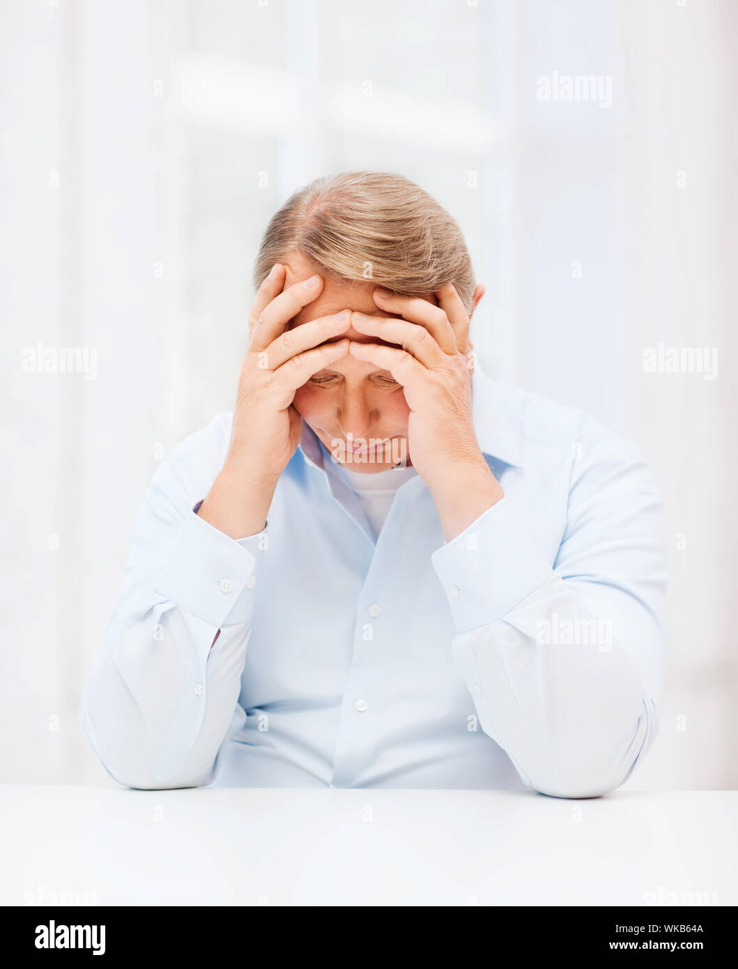 Oldness oldness, business and people concept - stressed old man holding head at ...