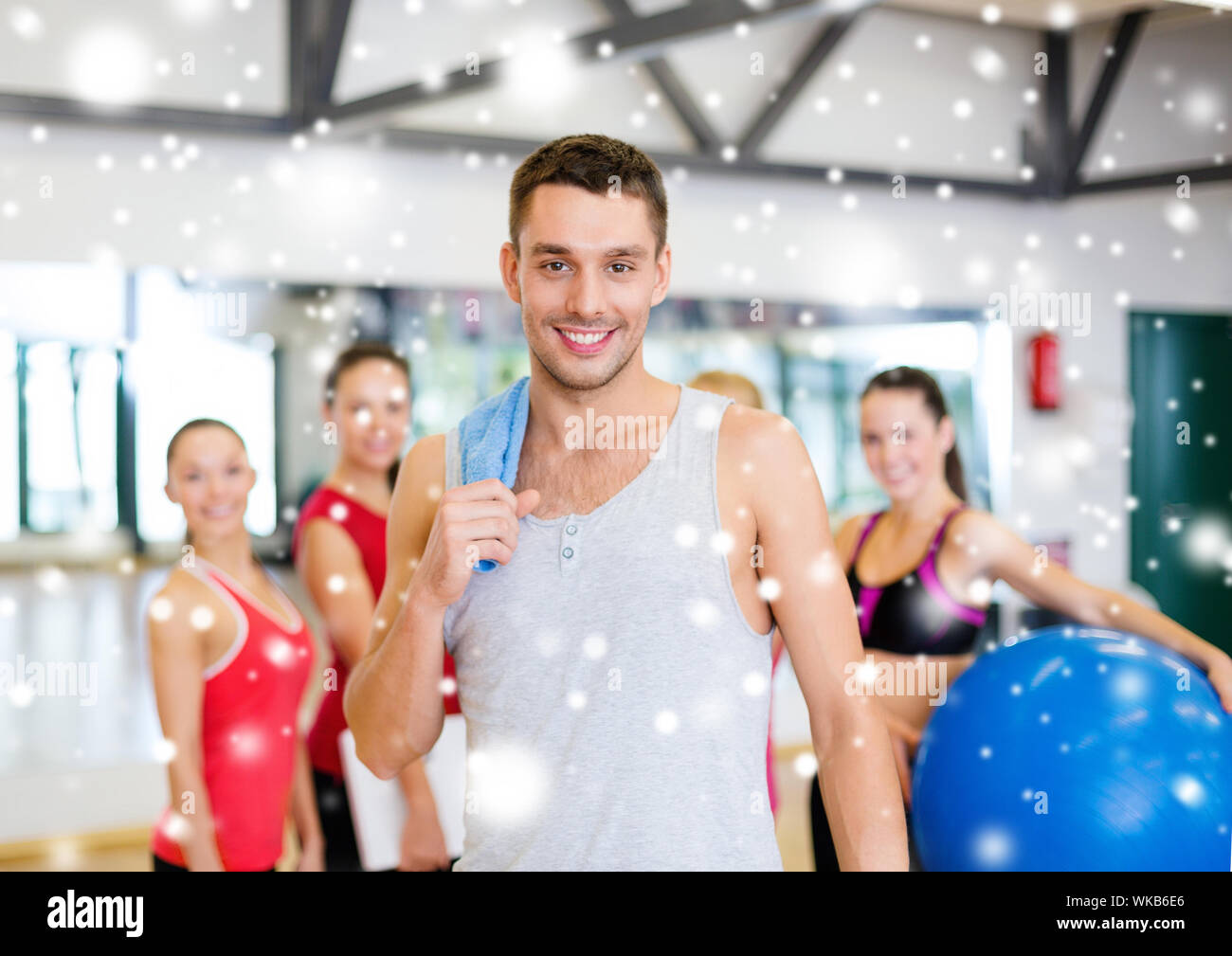 smiling man standing in front of the group in gym Stock Photo - Alamy