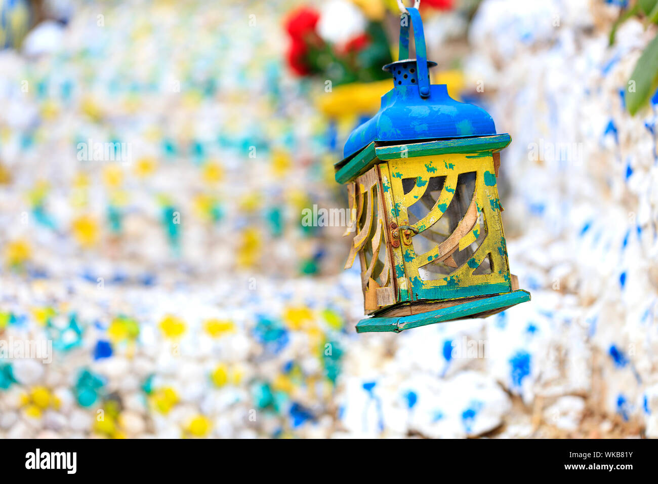Old oriental wooden oil lamp with stainedglass windows on a blurry