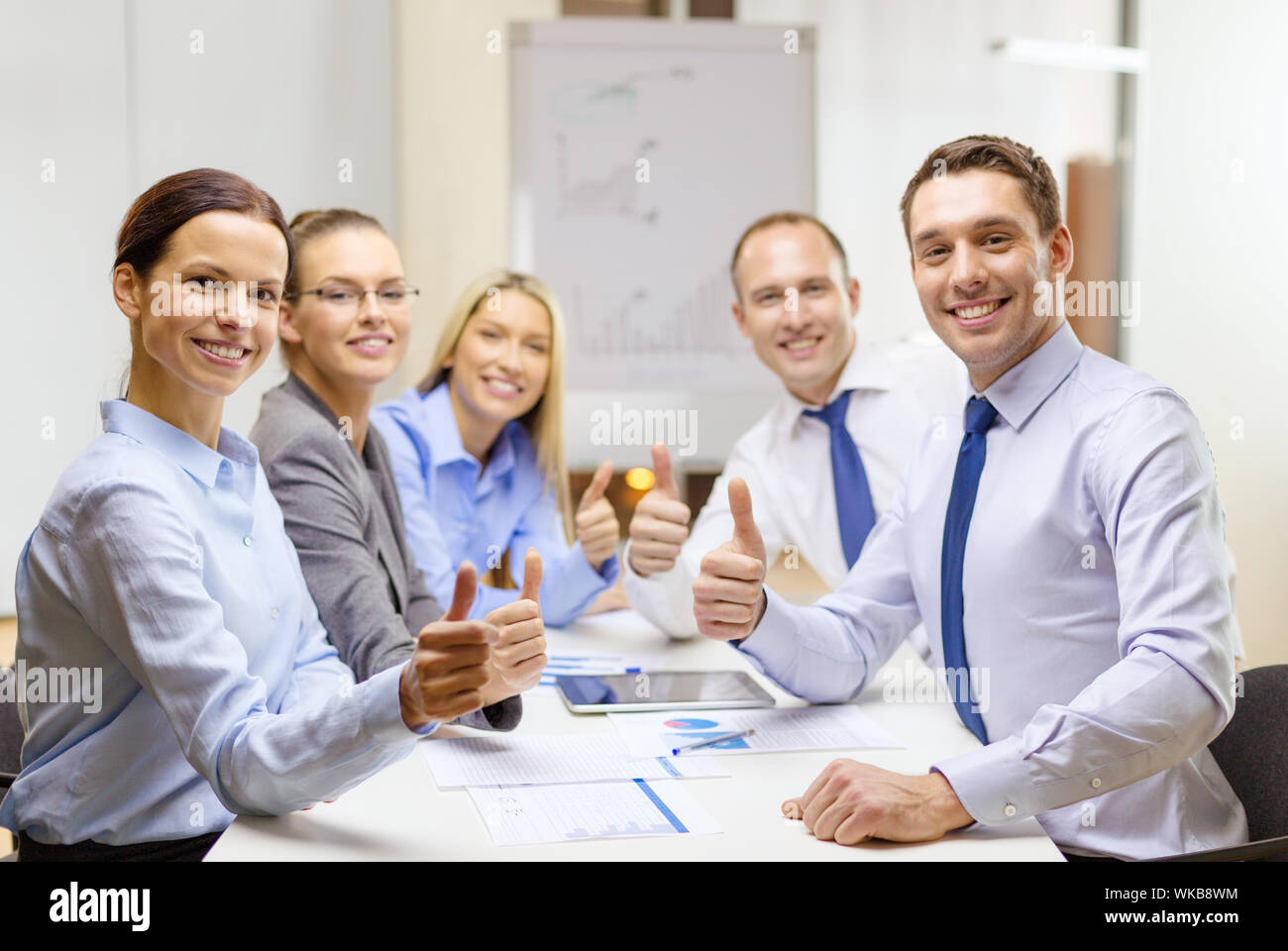 business team showing thumbs up in office Stock Photo - Alamy