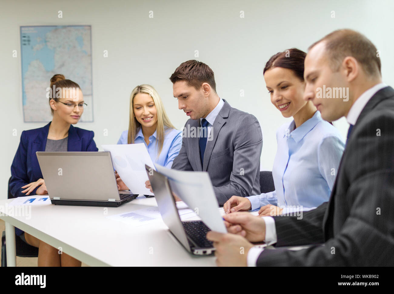 business, technology and office concept - smiling business team with ...