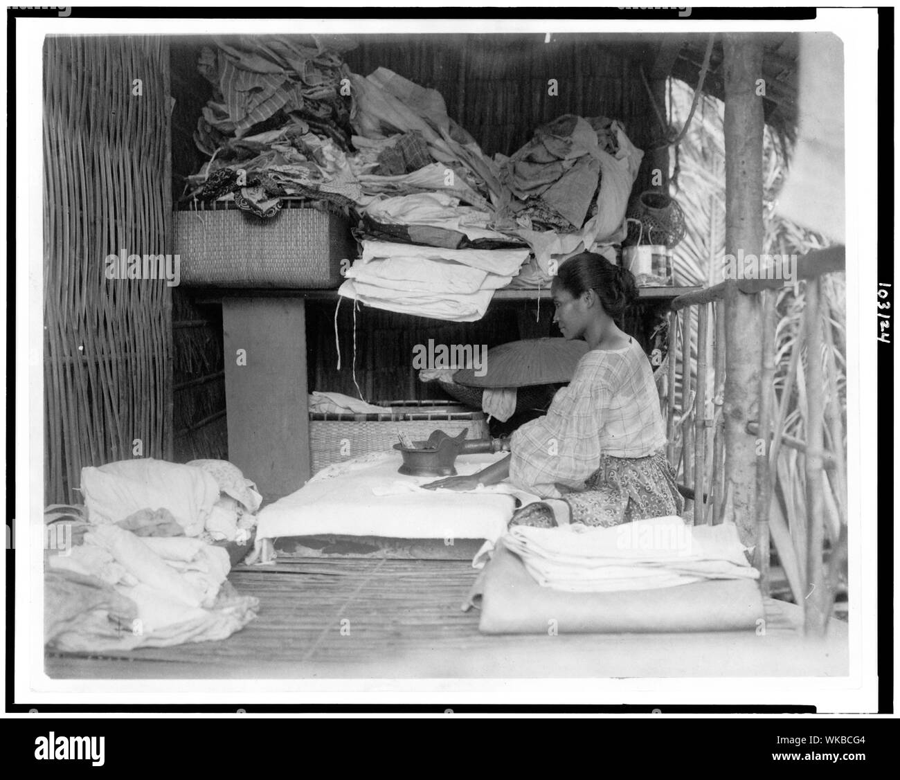 Javanese woman sitting in room working with textiles at exhibit featuring foreign participants at the World's Columbian Exposition, Chicago, Illinois Stock Photo