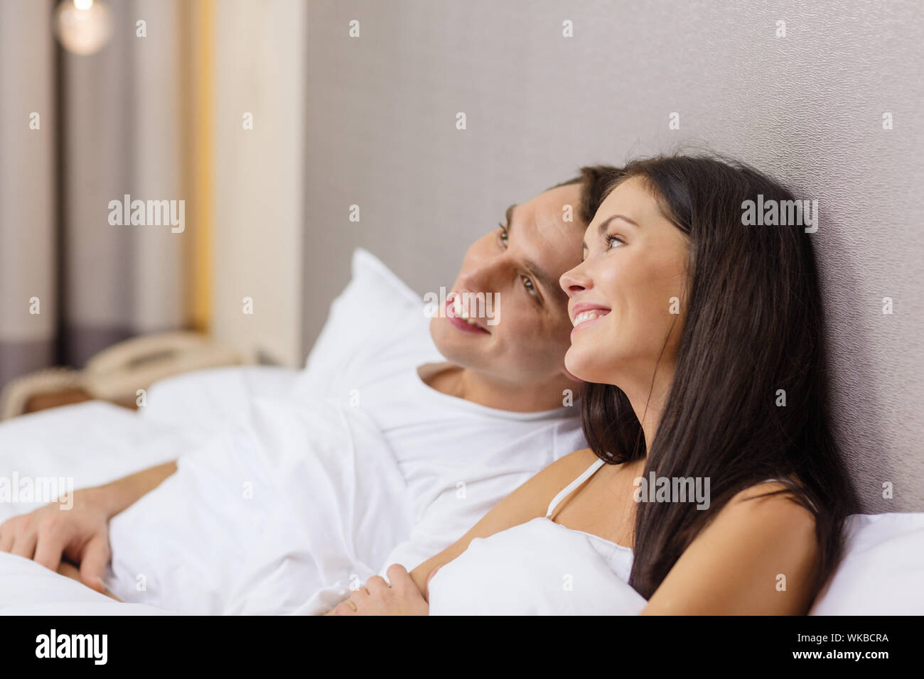 happy couple dreaming in bed Stock Photo