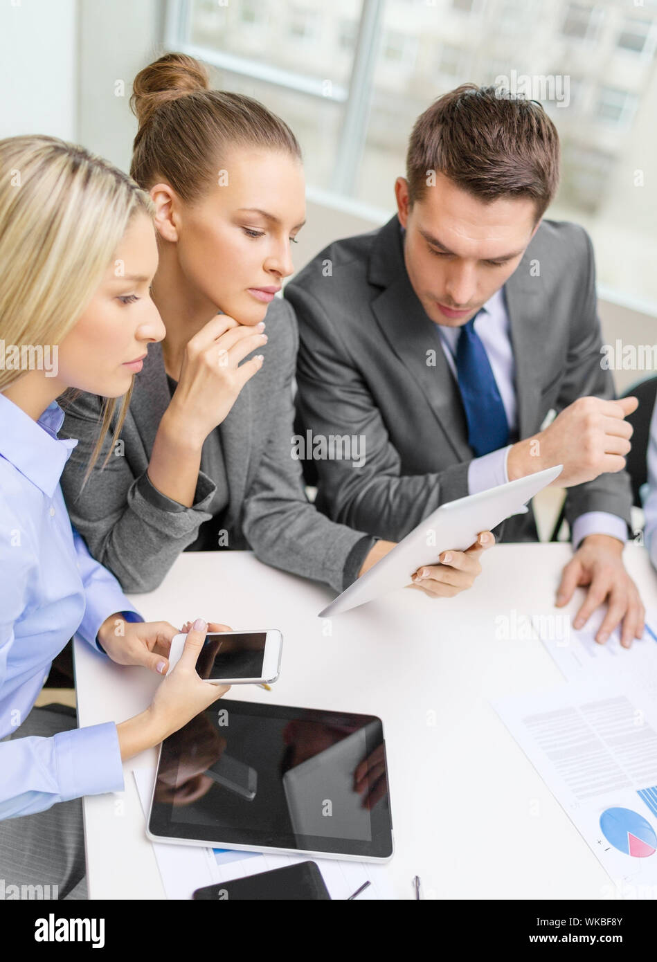 business team with tablet pc having discussion Stock Photo
