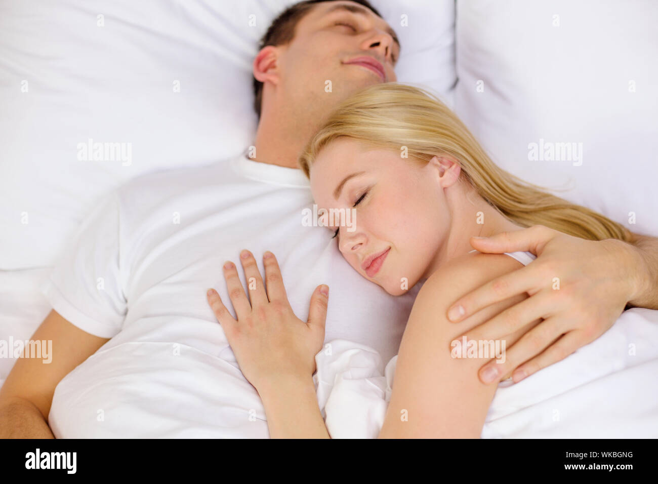 happy couple sleeping in bed Stock Photo - Alamy
