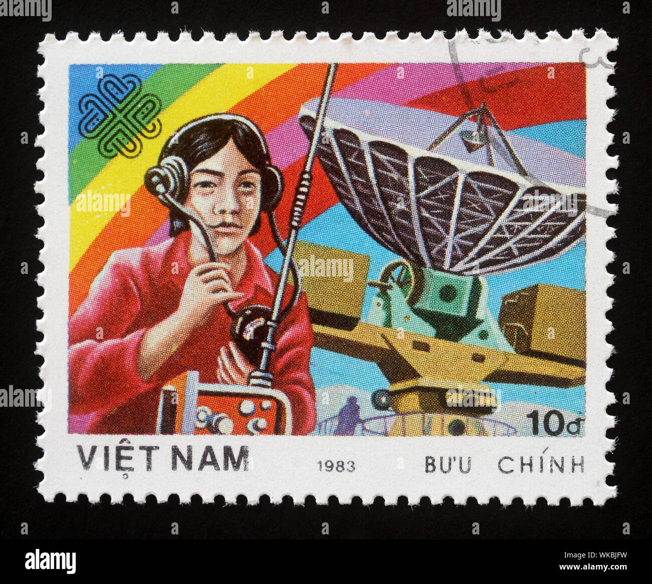 Stamp printed in Vietnam shows Radiooperator and antenna, World Communication Year, circa 1983. Stock Photo