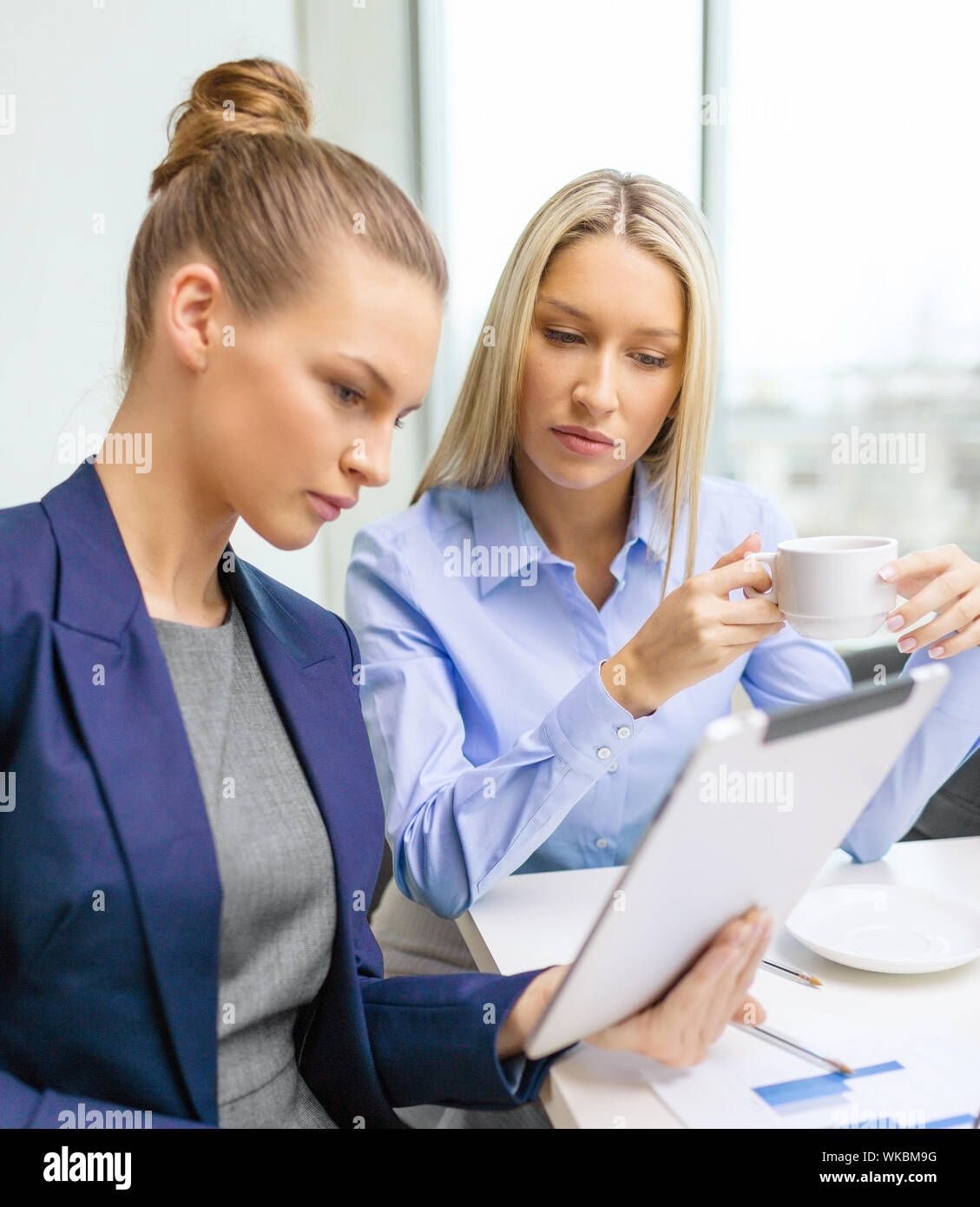 business team with tablet pc having discussion Stock Photo