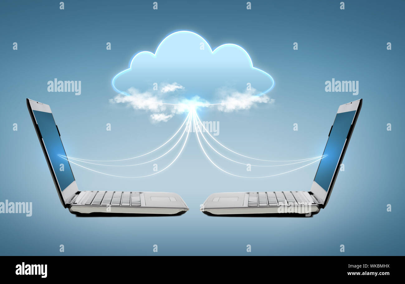 two laptop computers with world map hologram Stock Photo