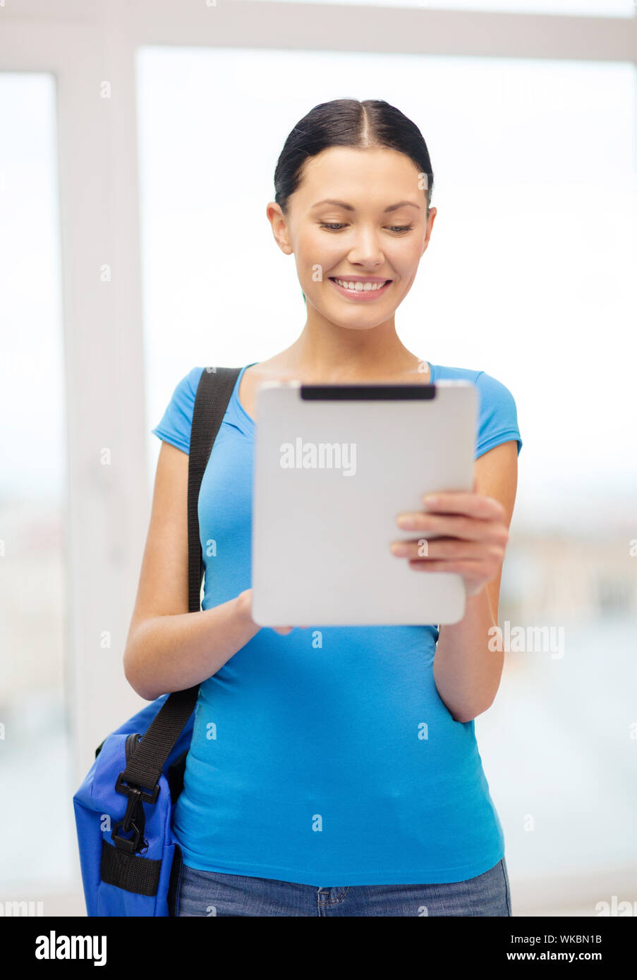 smiling female student with tablet pc and bag Stock Photo - Alamy