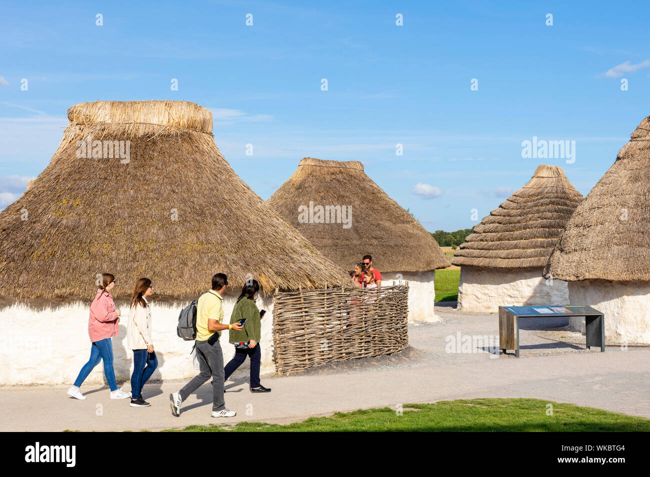 People visiting the reproduction Neolithic Houses at the Stonehenge visitor centre Stonehenge near Amesbury Wiltshire england uk gb Europe Stock Photo