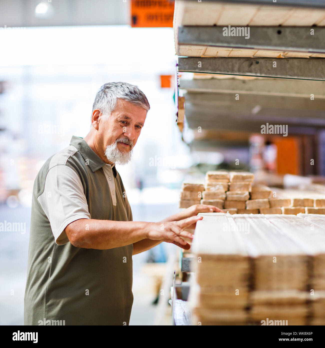 Man buying construction wood in a DIY store for his DIY home re