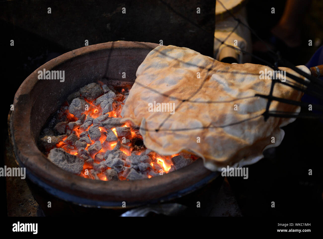 High Angle View Of Food Cooking Over Fire Pit At Night Stock Photo