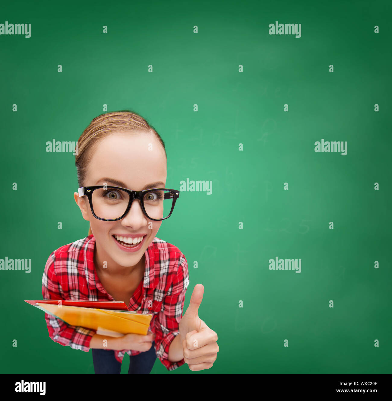 student in glasses with folders showing thumbs up Stock Photo - Alamy