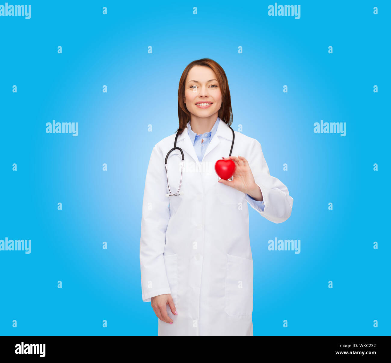 smiling female doctor with heart and stethoscope Stock Photo - Alamy
