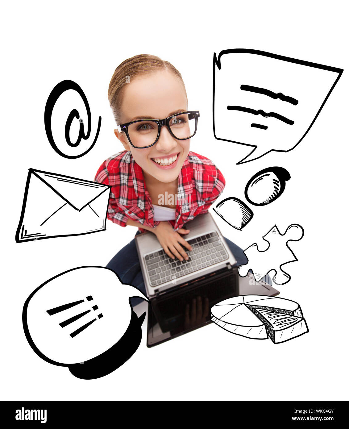 smiling teenage girl in eyeglasses with laptop Stock Photo