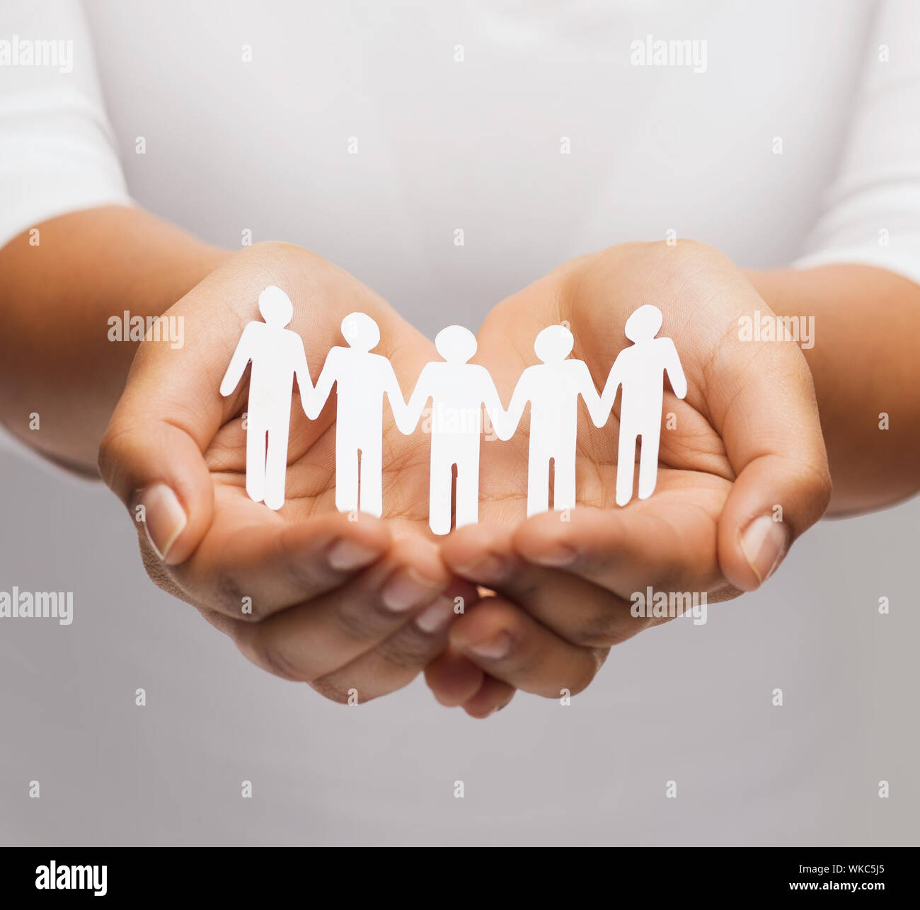 relationships and love concept - womans hands showing paper cutout team Stock Photo