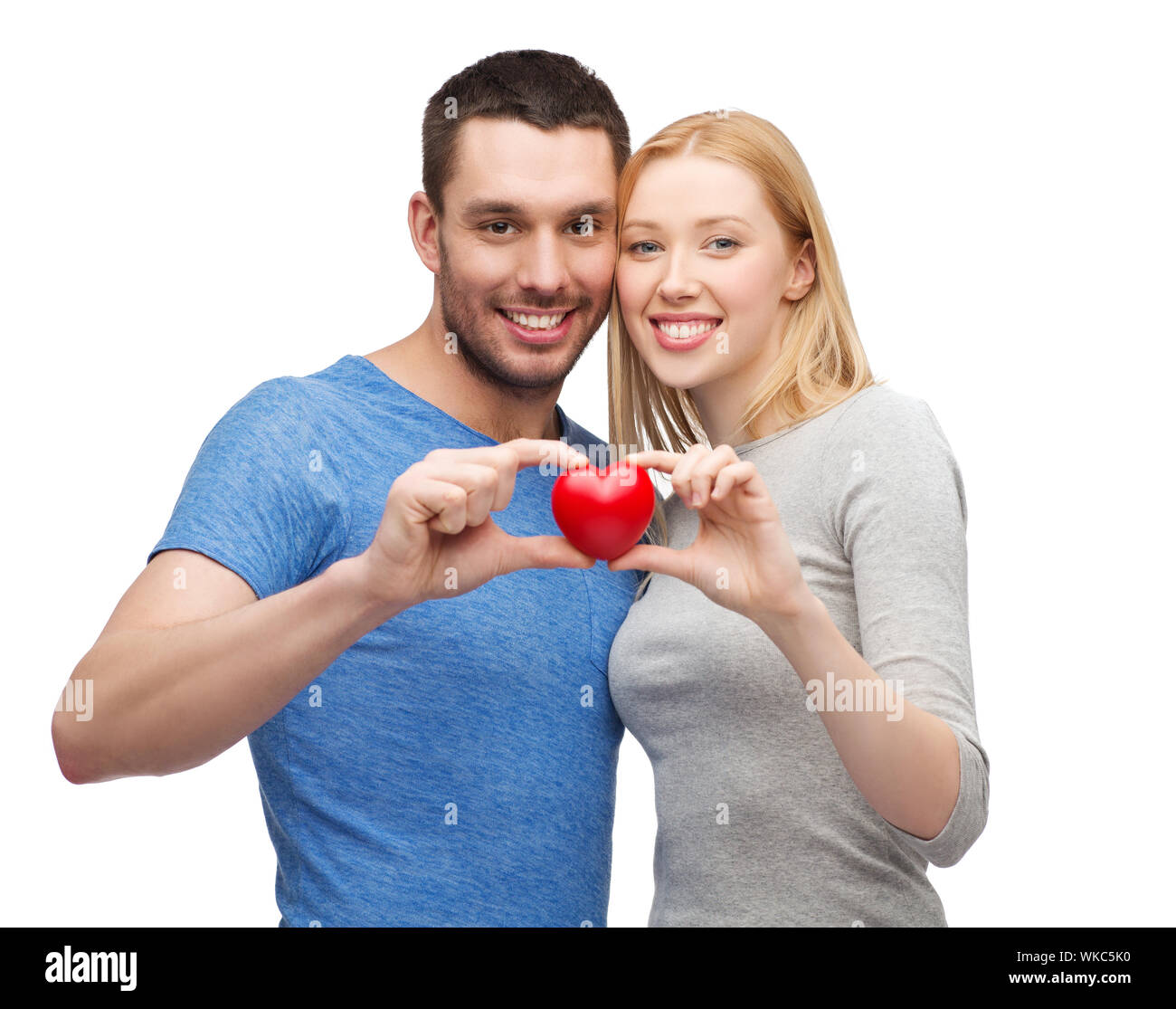 smiling couple holding small red heart Stock Photo