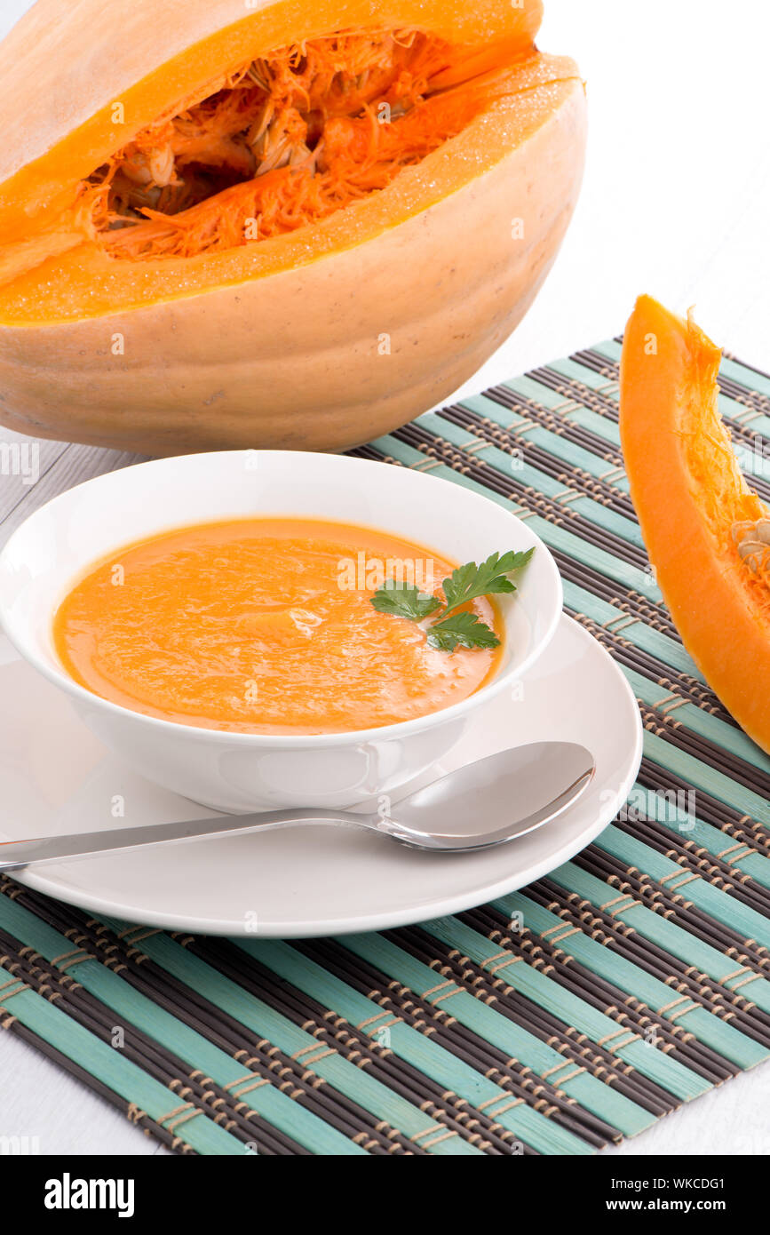 Pumpkin soup on white wood background Stock Photo - Alamy