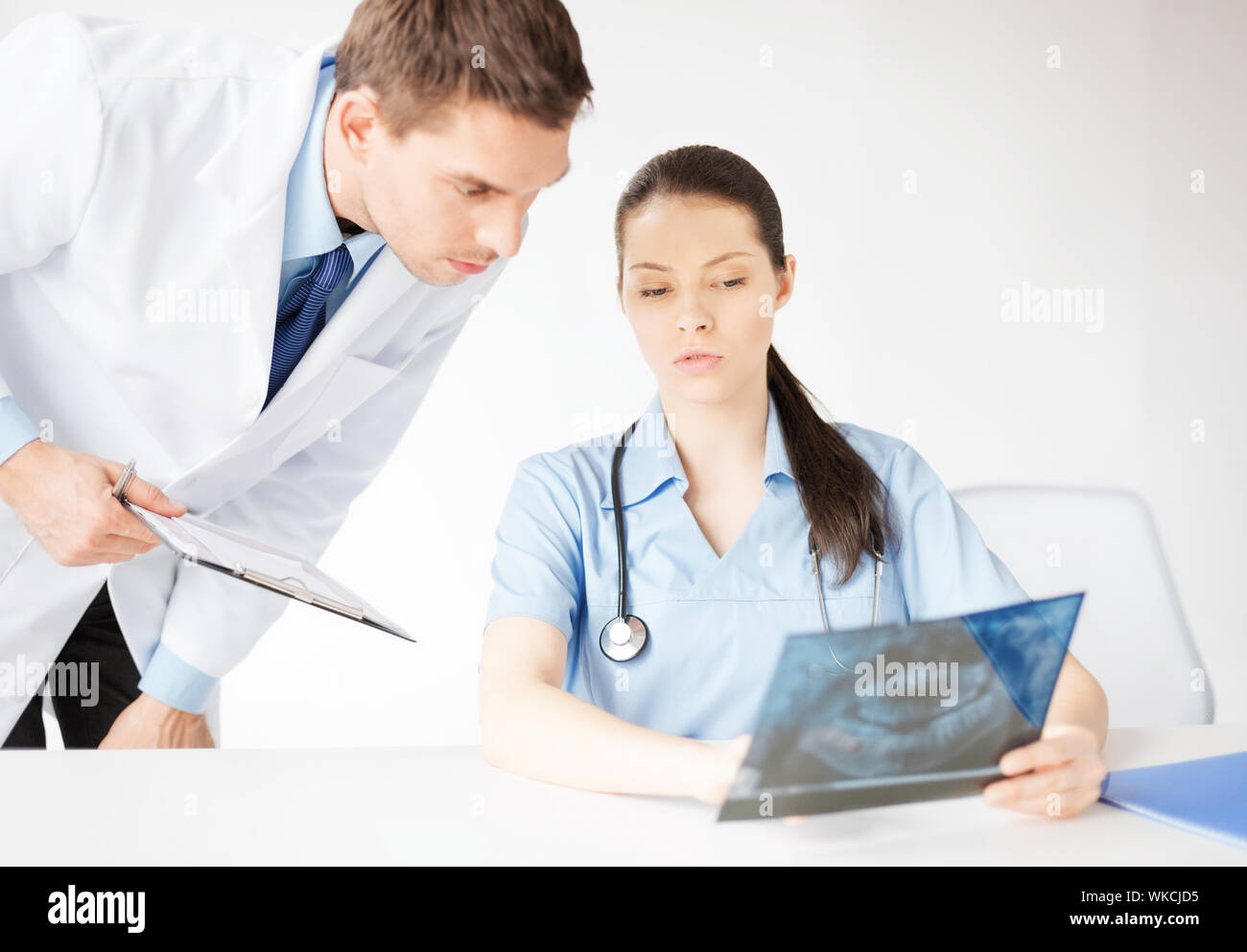 two medical workers looking at x-ray Stock Photo