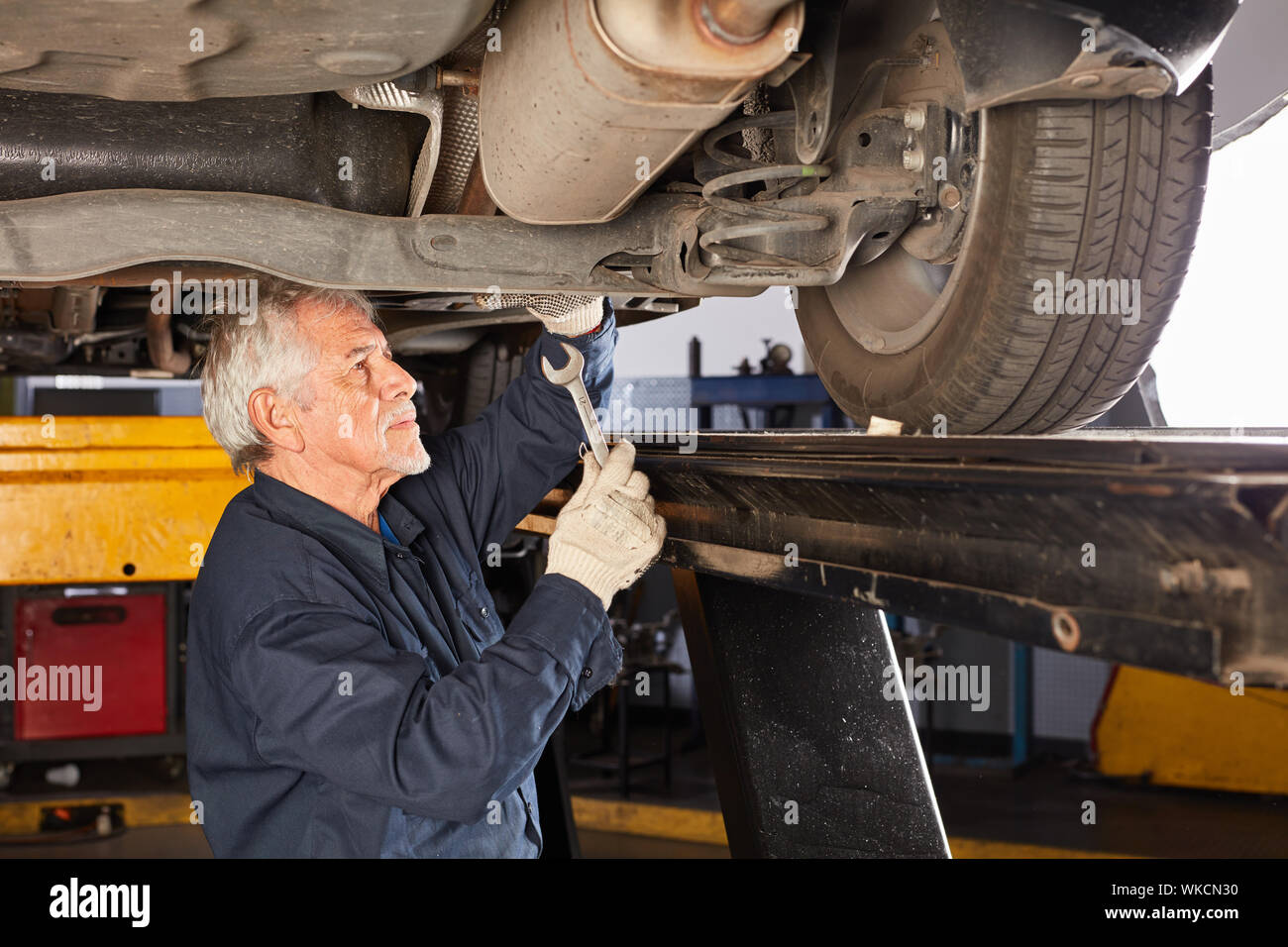 Experienced mechatronics engineer or mechanic in the repair or inspection of car Stock Photo