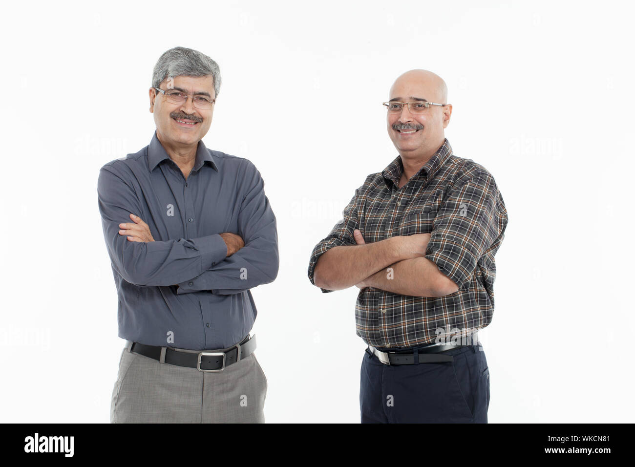 Two businessmen standing together and smiling Stock Photo - Alamy