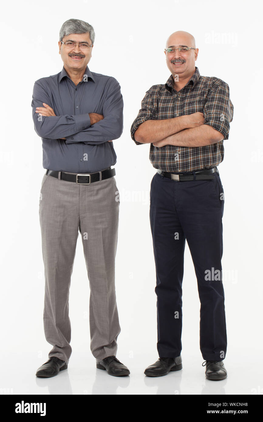 Two businessmen standing together and smiling Stock Photo - Alamy