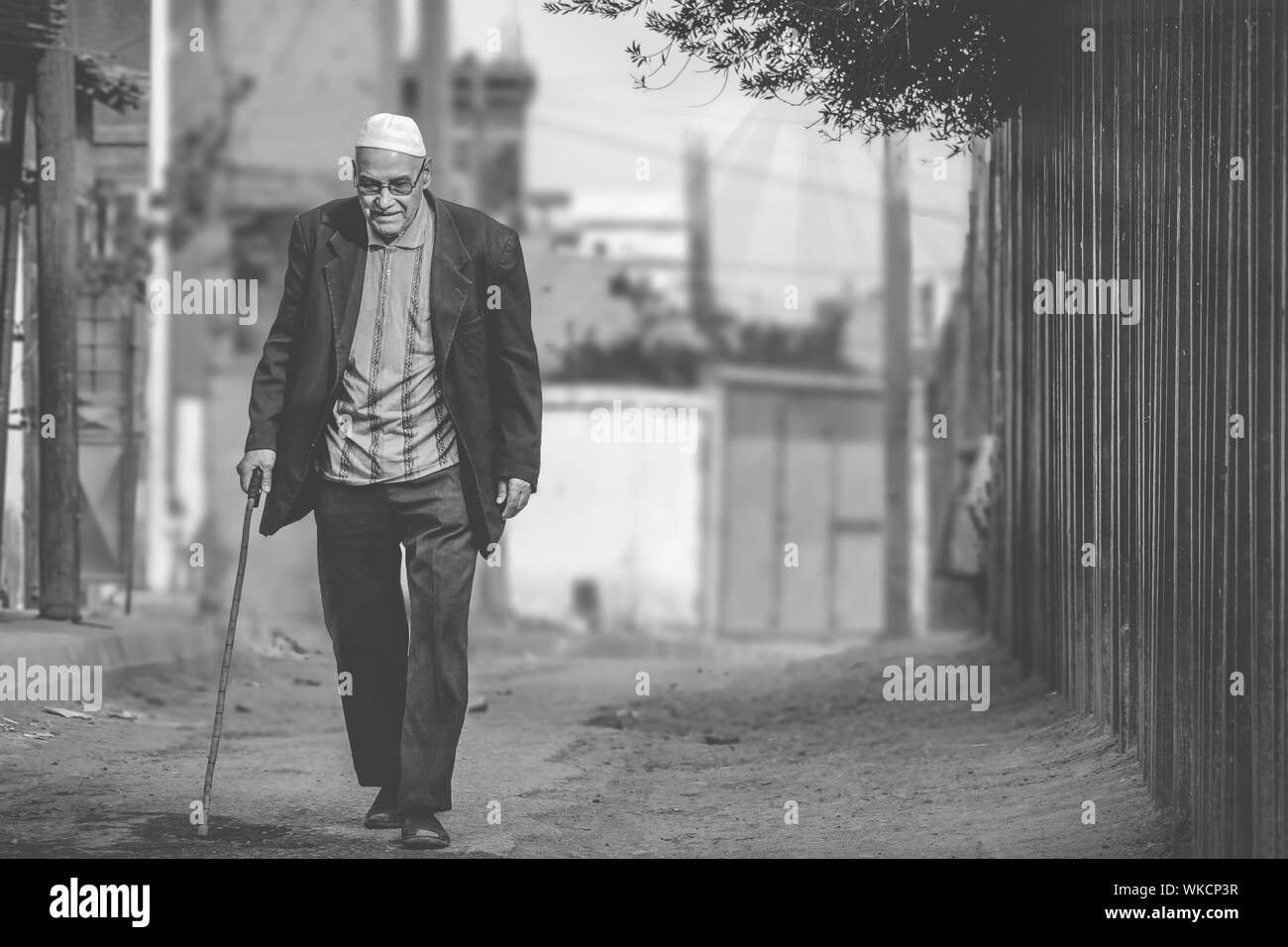 Full Length Of Man Walking With Cane Stock Photo Alamy