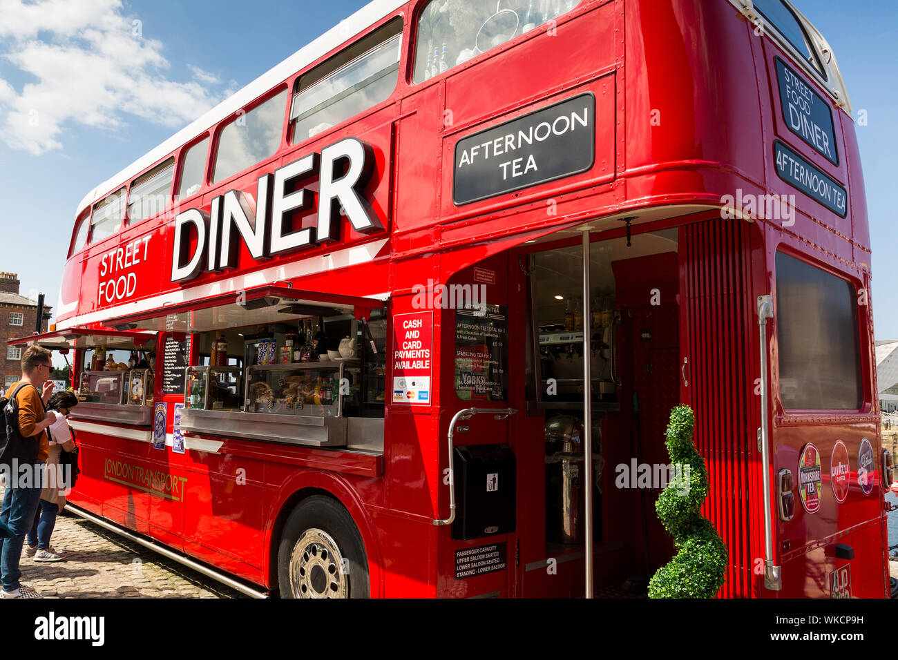 Routemaster bus converted into street cafe diner restaurant facility. Liverpool albert docks. Tourism in Merseyside England UK. Stock Photo