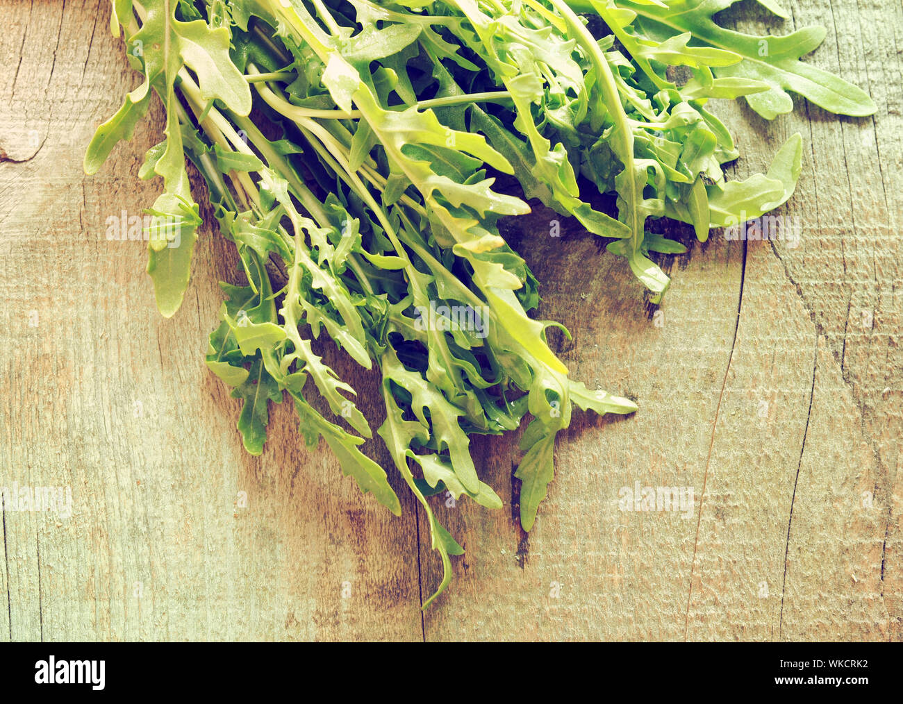 Close-up Of Arugula On Wooden Table Stock Photo
