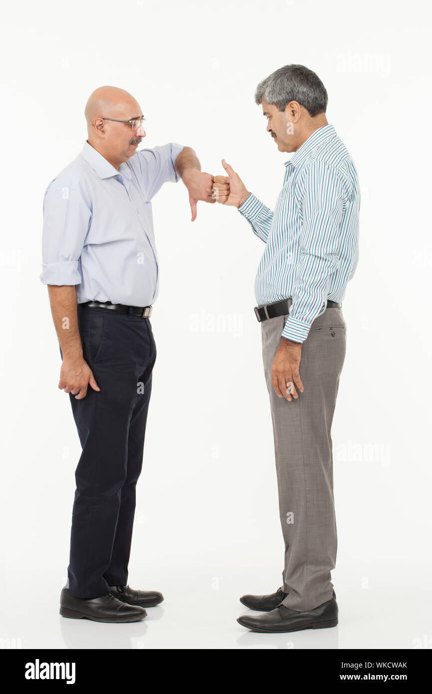 Businessmen showing thumb down and thumb up symbol Stock Photo