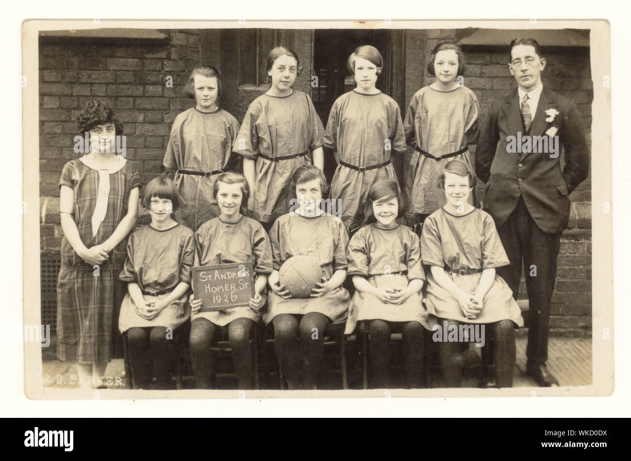Early 1900's postcard of girl's netball team, smiling and looking happy, St. Andrew's school, Homer Street, Manchester, England, U.K. dated 1926 Stock Photo