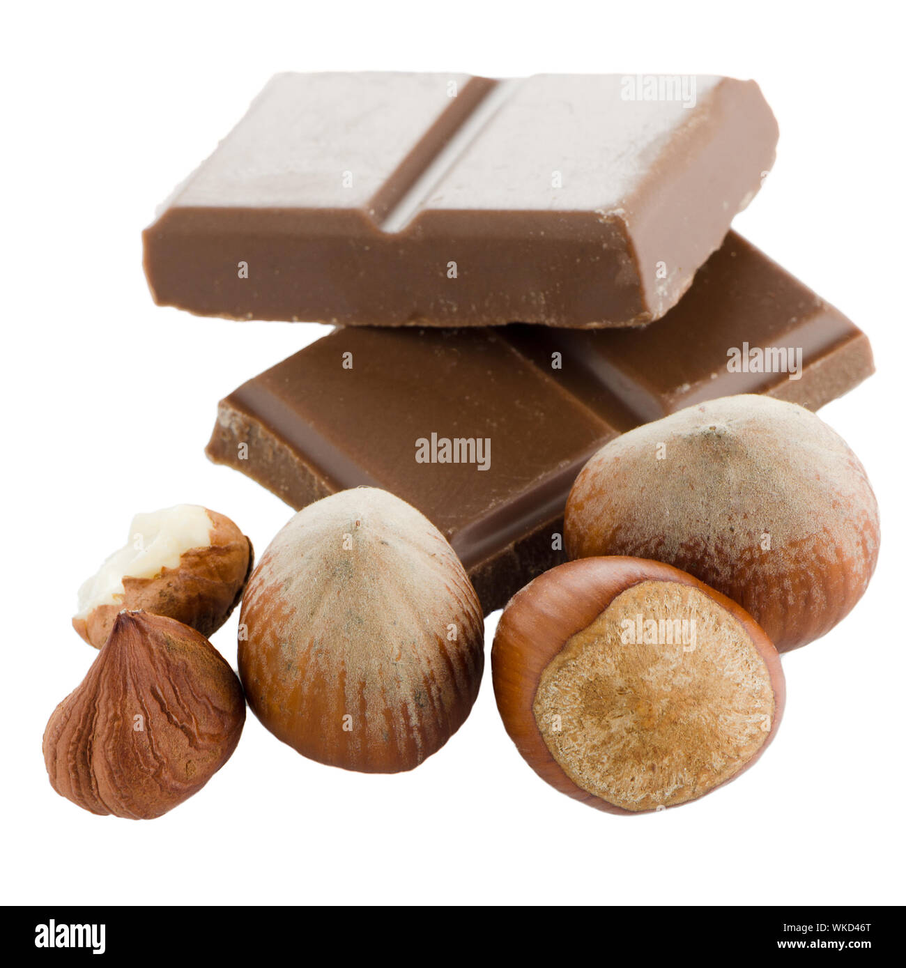 Chocolate parts and cinnamon sticks isolated on white background Stock