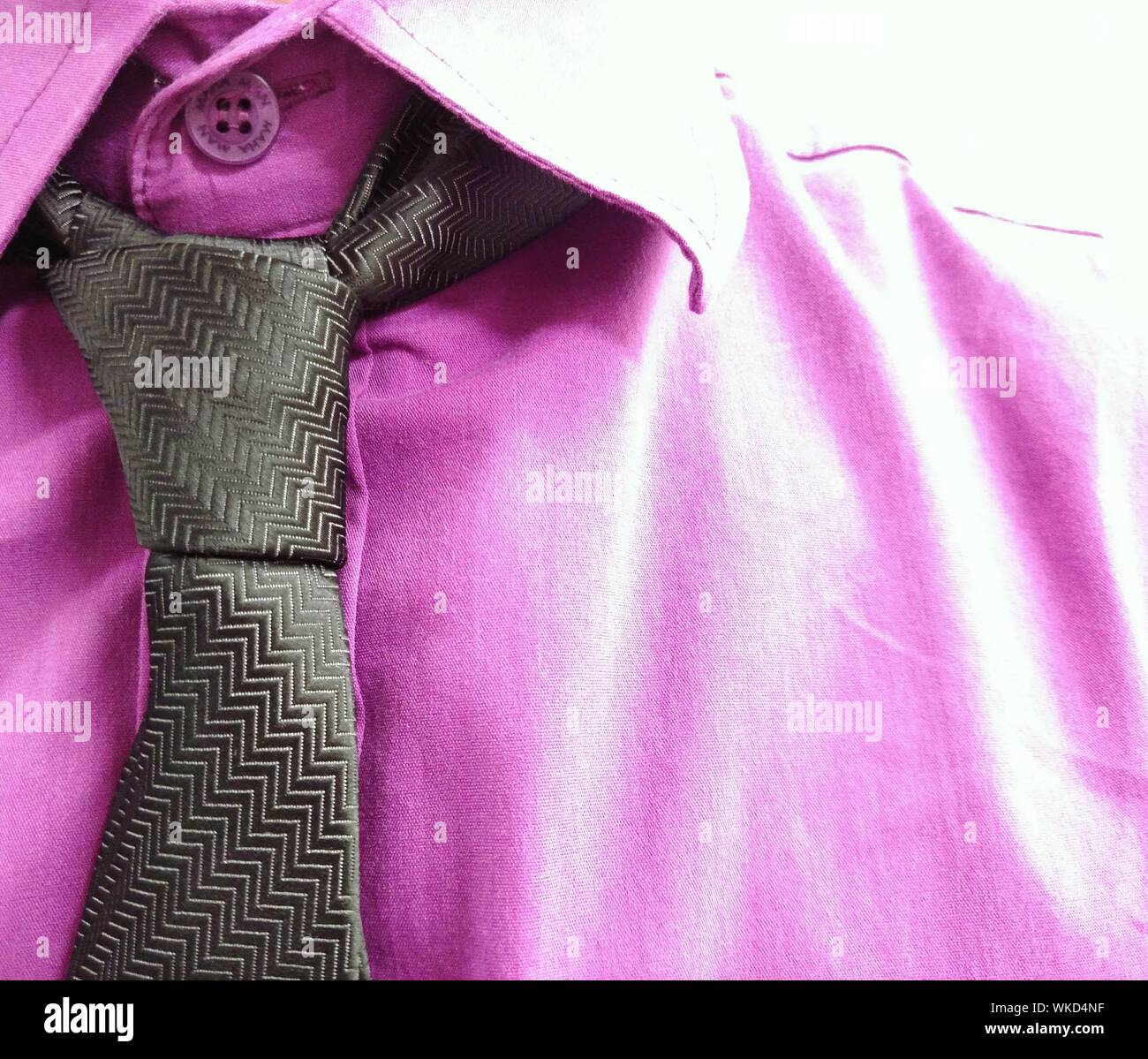 Midsection Of Businessman With Purple Shirt And Tie Stock Photo