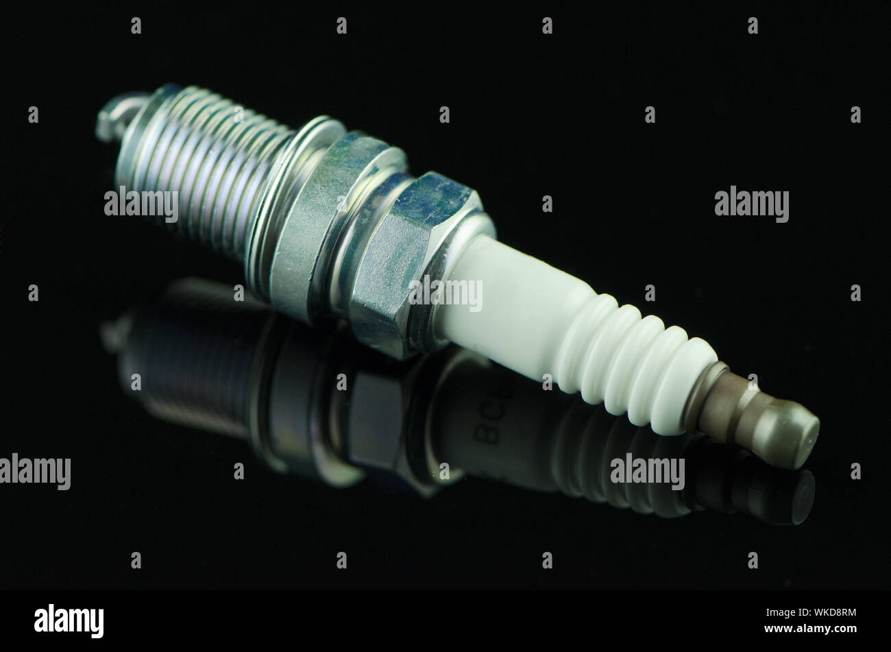 Spark-plug on black reflective background Stock Photo