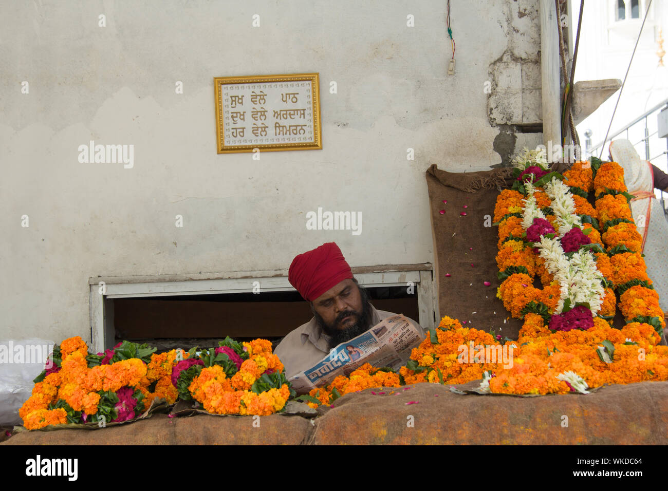 Man selling flowers in Gurudwara, Gurudwara Bangla Sahib, New Delhi, India Stock Photo
